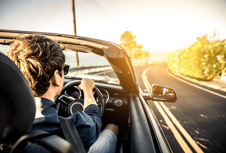 Man driving convertible car