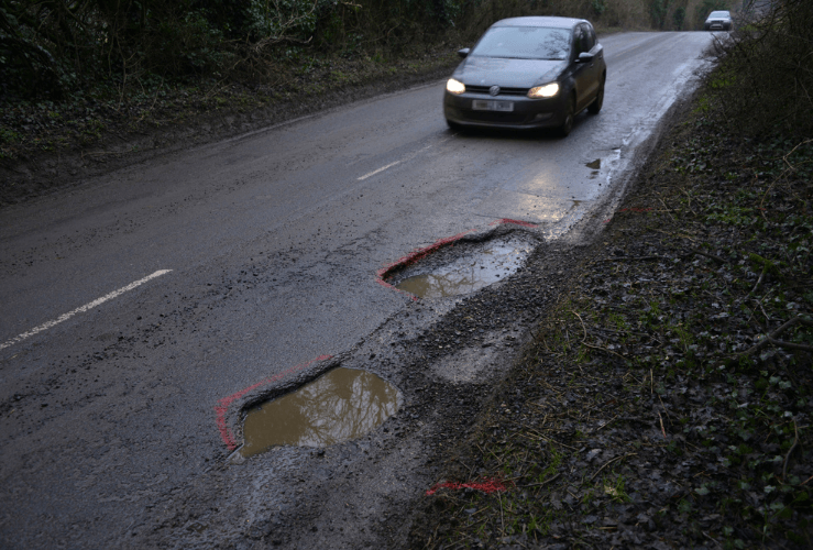 Car approaching a pothole