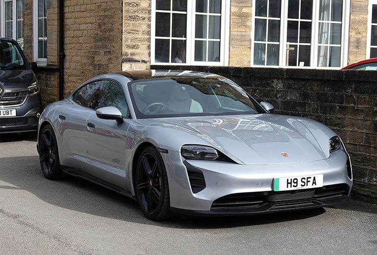 Silver electric sports car parked on a street