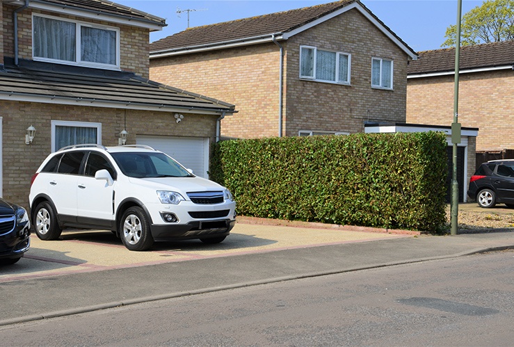 A White car parked on a driveway