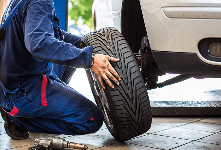 Mechanic holding a tyre