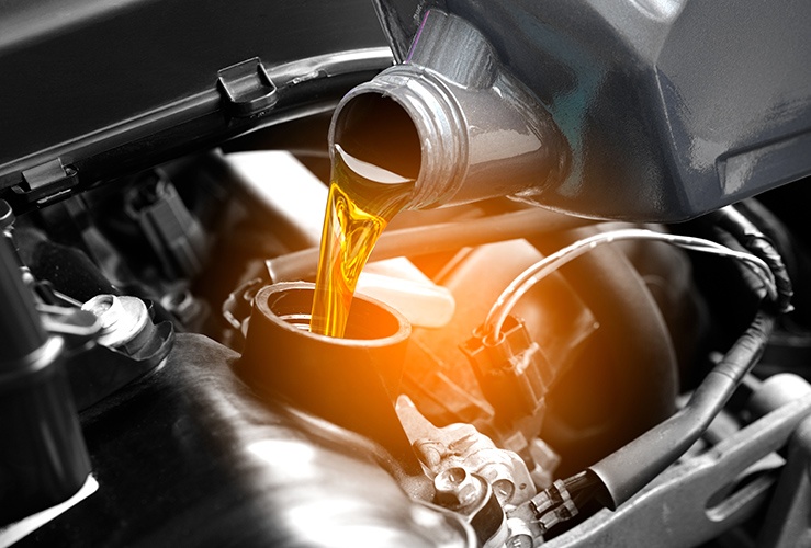 Filling up a car with engine oil