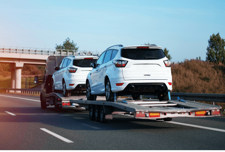 Broken down vehicles on back of tow truck