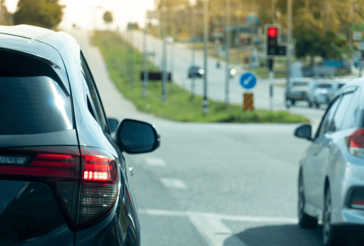 Two cars waiting at red traffic lights