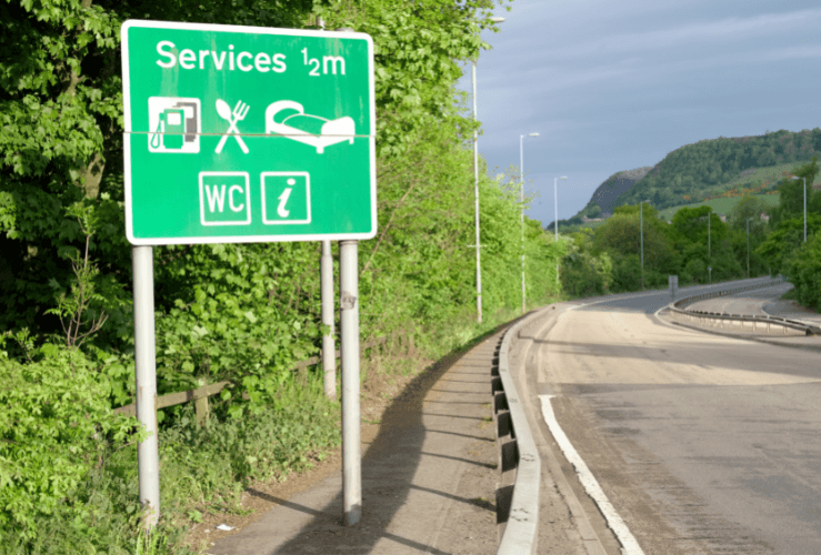 Sign for services on road